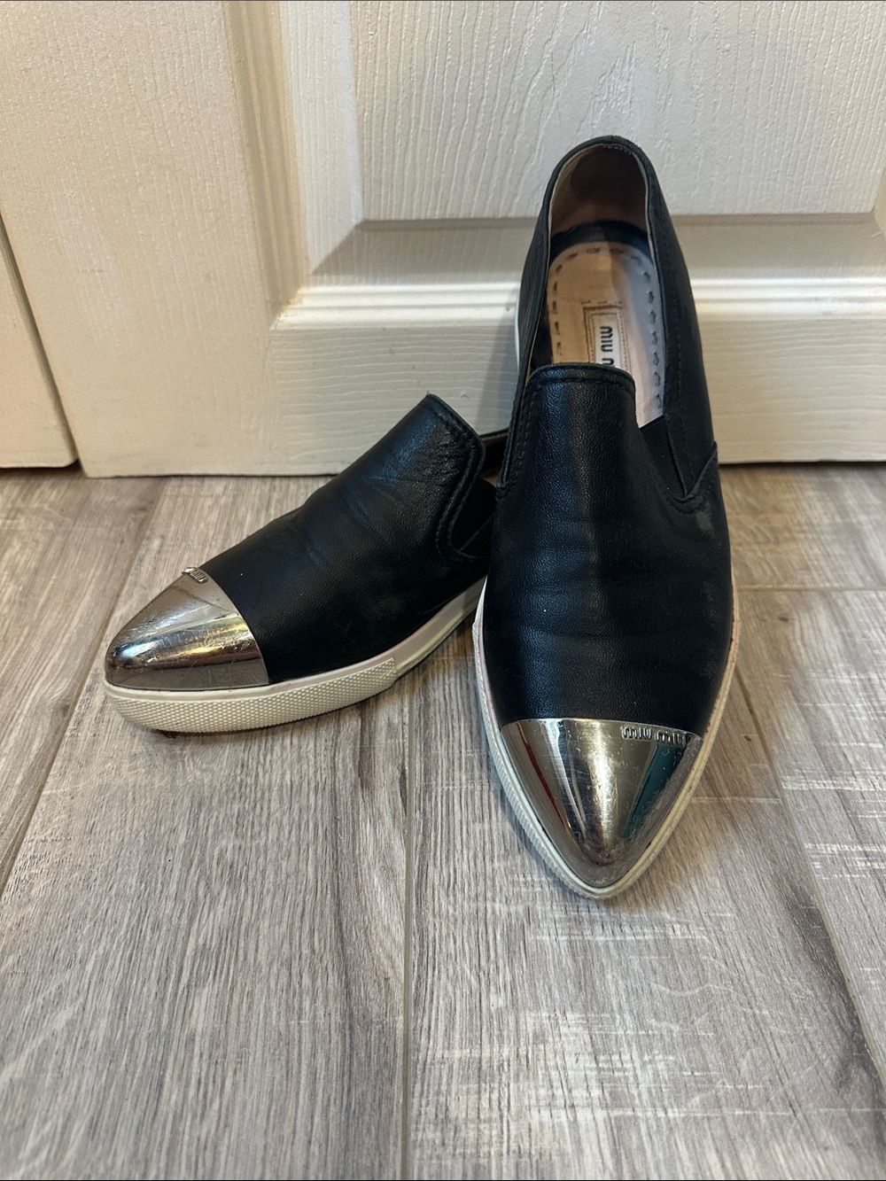 Miu Miu Black Leather Slip-On Sneakers with Silver Metal Cap